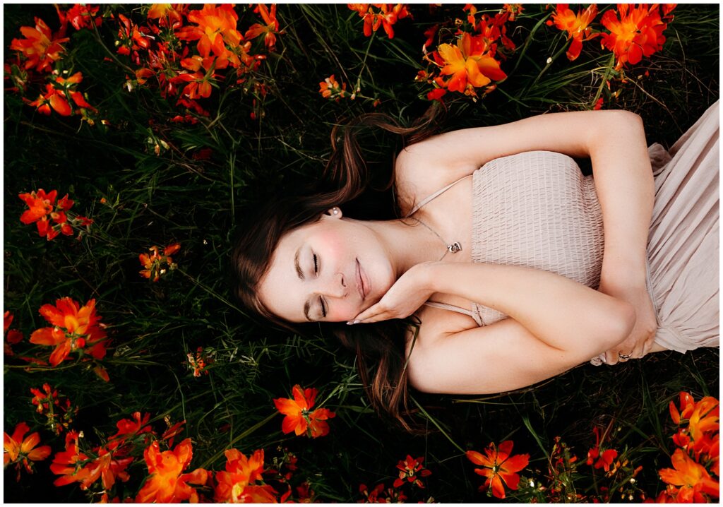 Seattle senior spring portraits, senior girl laying in wildflowers 