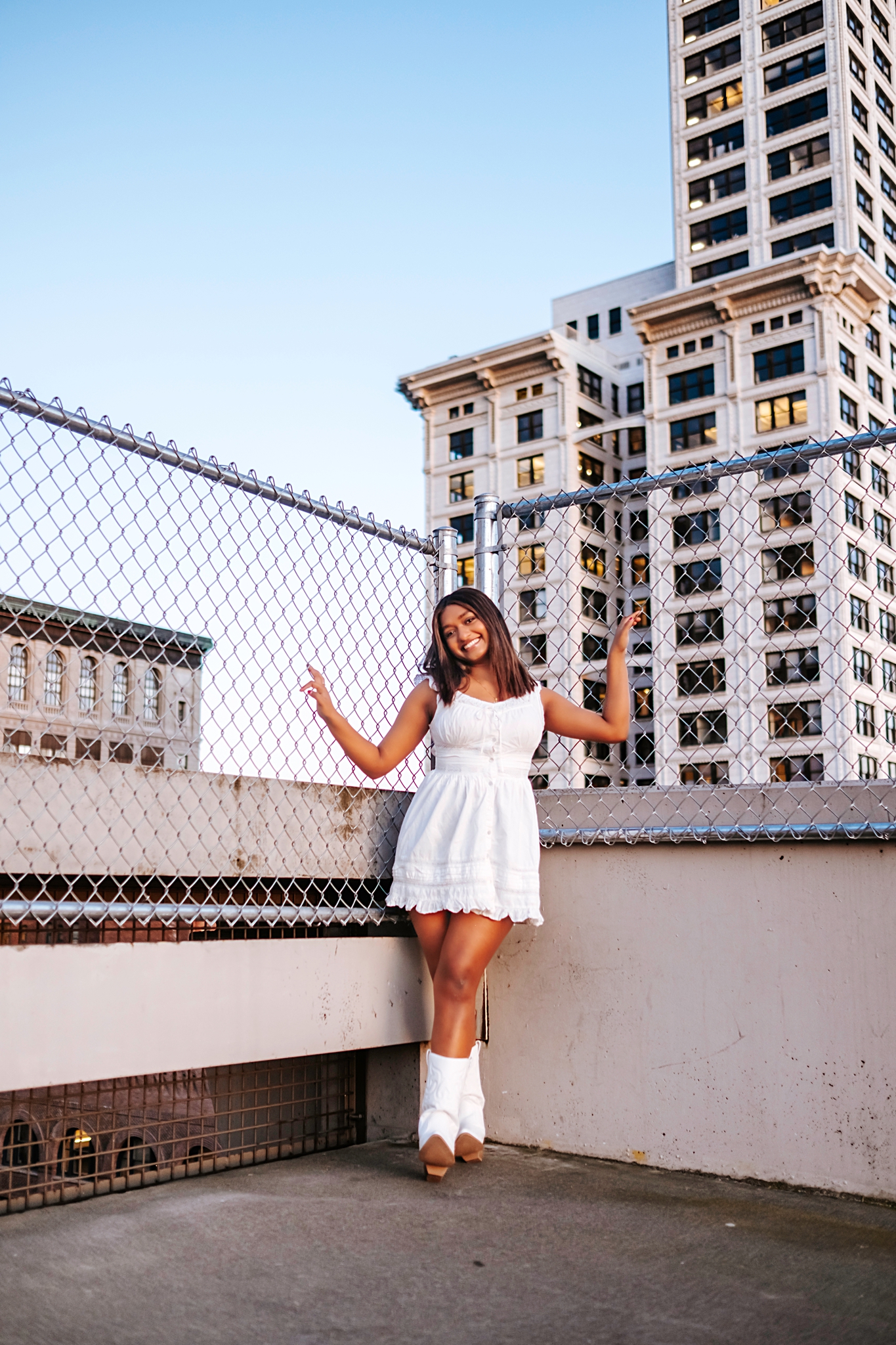 Seattle senior on a rooftop in Pioneer Square with the Smith Tower behind her